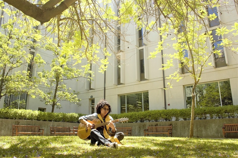 Kat playing guitar on UC Davis campus