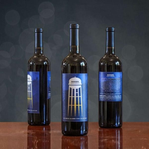 three bottles from the alumni wine collection on a table
