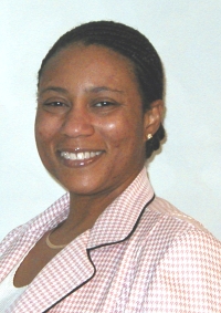 Picutre of Ana Floyd in blazer in front of blue backdrop