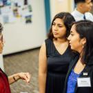 UC Davis students interacting with an alumna at a career fair