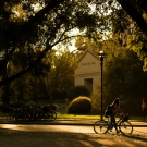 image of student walking a bike