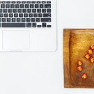 Overhead picture of a pumpkin and laptop.