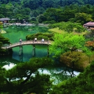 picture of a bridge over a pond surrounded by water