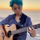 Kat playing the guitar at San Diego Pacific Beach Pier