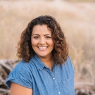 Portrait photo of Anu Johl-Singh sitting outdoors