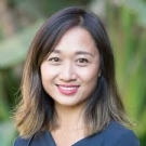 Patricia Châu Nguyễn poses in front of a blurred outdoor scene.