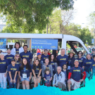 image of group in front of parade tram