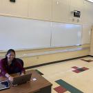 Person in a classroom sitting in front of a computer