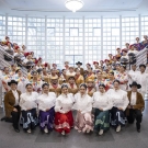 Members of Danzantes Del Alma's 45th Annual Show stand together between two staircases
