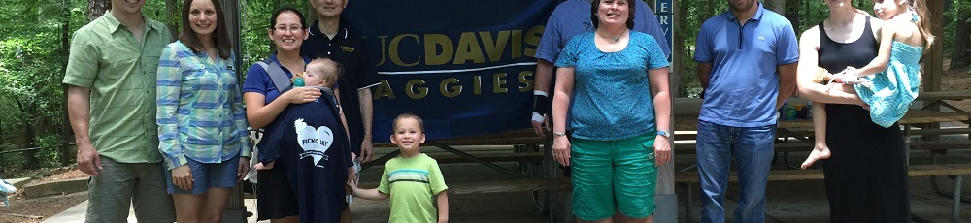 Aggies standing outside with UC Davis flag
