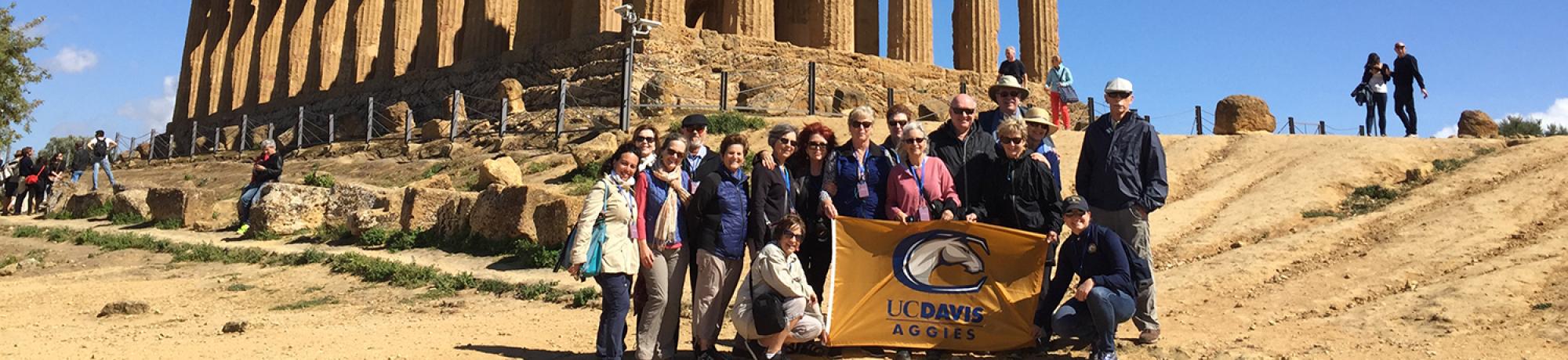 alumni in front of Italian ruins